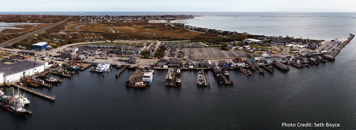 A body of water with boats and buildings along it    Description automatically generated with low confidence